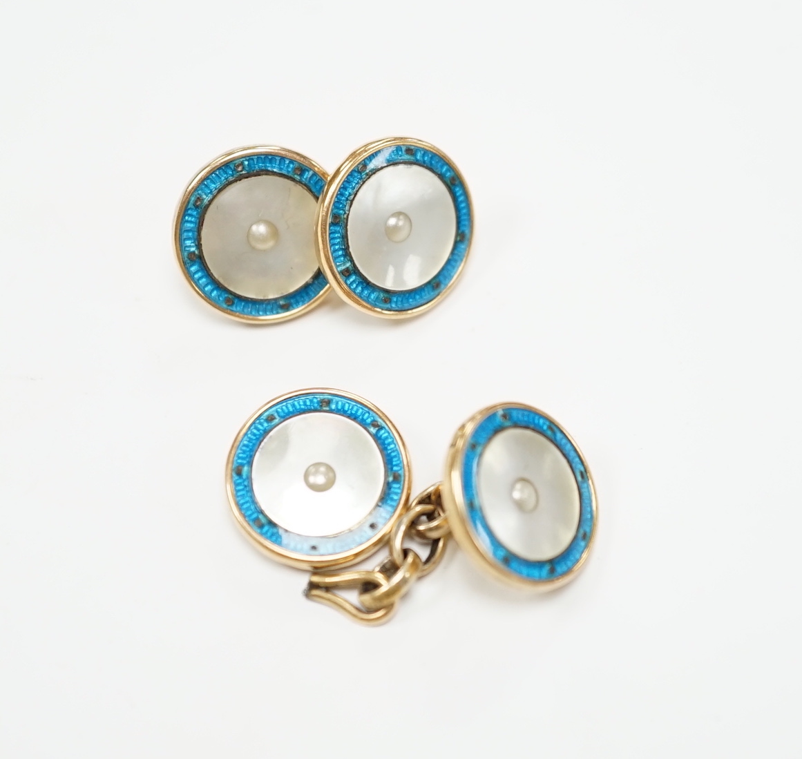 A pair of 9ct, mother of pearl and enamelled circular cufflinks, one link detached, 13mm, gross weight 6.5 grams.